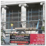 04 Scaffolding with parish sign listing current Mass times in the foreground