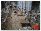 07 Before the sub-floor was poured the east aisle crypt area with earthen floor and the foundation of a support pillar visible